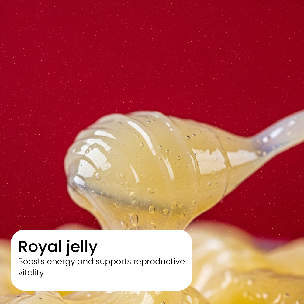 Spoon filled with royal jelly against a red background